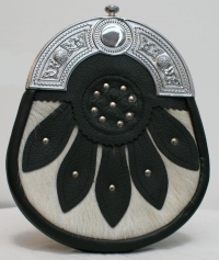 The SPORRAN is black leather with a Celtic cantle, a white cowhide base on the front overlayed with leather detailing and studs.